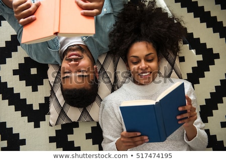 Stok fotoğraf: Happy Couple Reading Book At Home