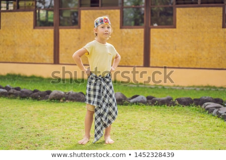 Stockfoto: Boy Tourist In Sarong National Balinese Clothing