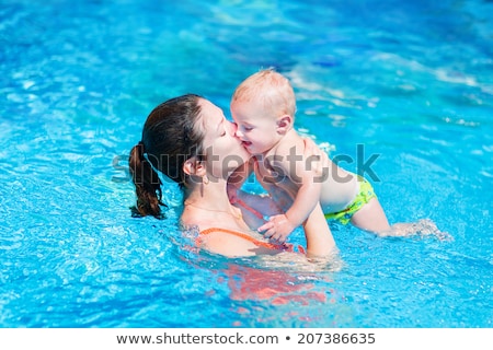 Stock photo: Young Mother Teach Her Little Son How To Swim In A Swimming Pool