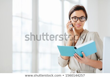 Stock fotó: Photo Of Attractive Woman With Dark Hair Has Telephone Conversation Agrees To Meet With Colleague