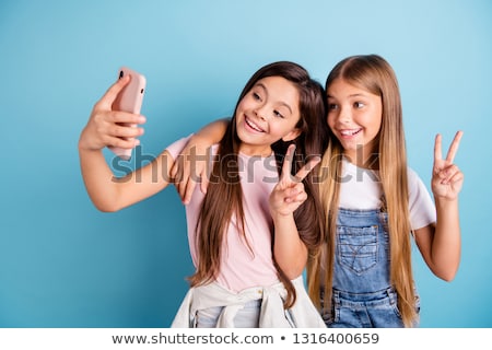 Stockfoto: Photo Of Pretty Joyful Woman Laughing And Gesturing Peace Sign
