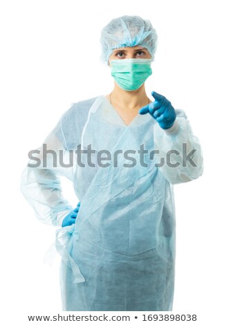 Stock photo: Smiling Female Nurse Pointing Stethoscope At Camera