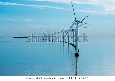 Stockfoto: Wind Turbine Power Generators Silhouettes At Ocean Coastline