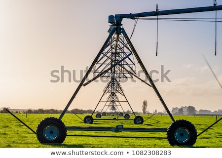Stok fotoğraf: Automated Farming Irrigation Sprinklers System In Operation