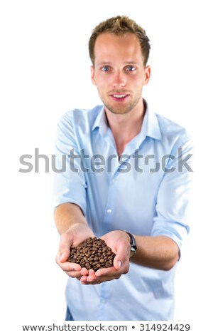 Stock fotó: Young Salesman Showing Hands Full With Coffee Beans