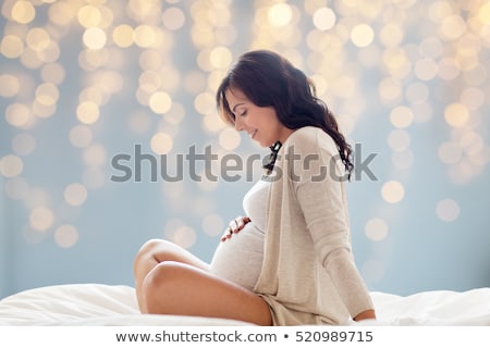 Foto stock: Happy Pregnant Woman Touching Her Big Belly