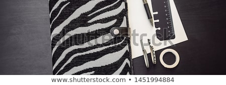 Stockfoto: Notepad And Stationery On A Black Background Planner For Business And Study Fans Of Stationery