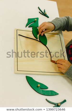 Stok fotoğraf: Small Pupils In A Nursery School Handling Educational Puzzles