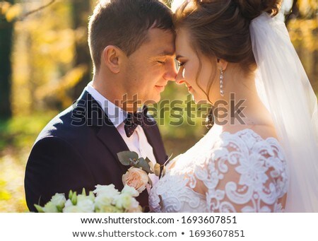 Сток-фото: Romantic Newlywed Couple With Eyes Closed Embracing In Park