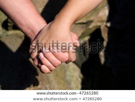 Foto d'archivio: Close Up Of Clasped Lovers Hands With Affection