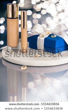 [[stock_photo]]: Holiday Make Up Foundation Base Concealer And Blue Gift Box Lu