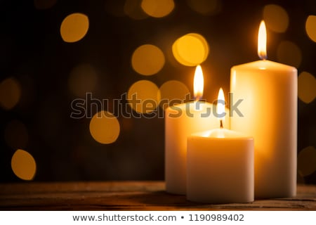 Stock photo: Three Golden Candles Burning In The Darkness