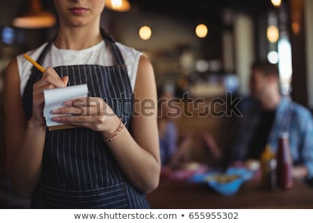 Stok fotoğraf: Waitress Taking Order In Restaurant