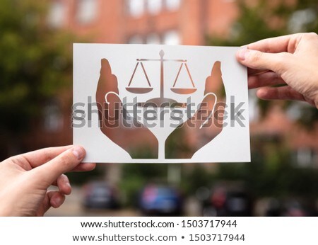ストックフォト: Hands Holding Paper With Cutout Hands Protecting Scales