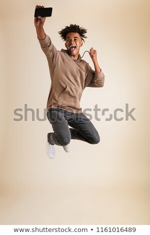 Foto d'archivio: Afro American Man Dressed In Hoodie Taking A Selfie Isolated