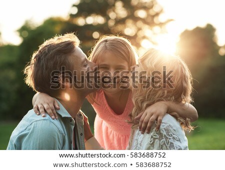 Foto stock: Cute Little Girls With Their Mom Outdoors