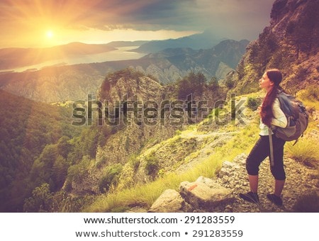 Stockfoto: Woman Standing On A Mountain And Gazing In The Distance