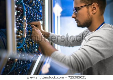 Stock photo: Young Programmer With Cables