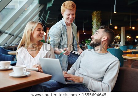 Foto stock: Three Clever College Students Discussing Points Of Presentation For Conference