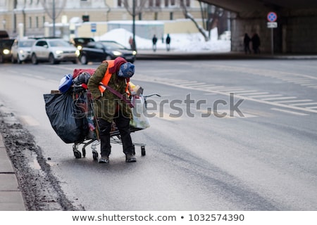 Foto d'archivio: Sad Drunk Homeless Woman On Bin