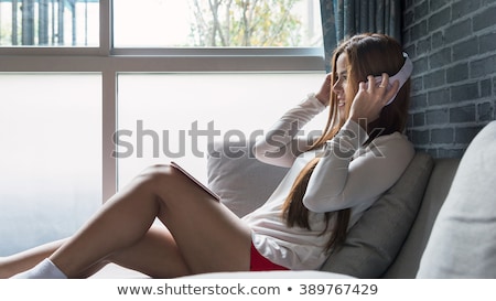 Foto stock: Young Attractive Woman Listing To Music