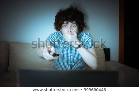 Сток-фото: Man Covering Mouth Watching Tv