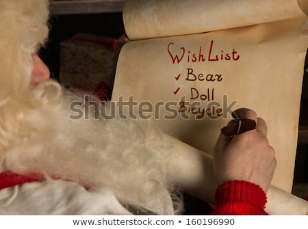 Stockfoto: Santa Claus Sitting At Home And Writing On Old Paper Roll To Do