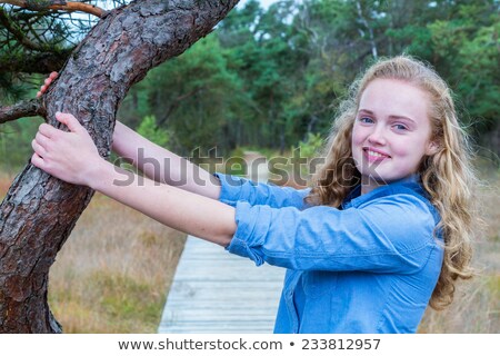 Stock fotó: Blonde Dutch Girl Holding Tree Trunk In Nature