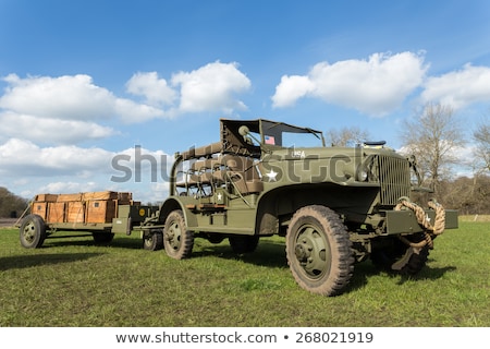 Foto stock: Military Army Jeep Pulling Trailer On Grass