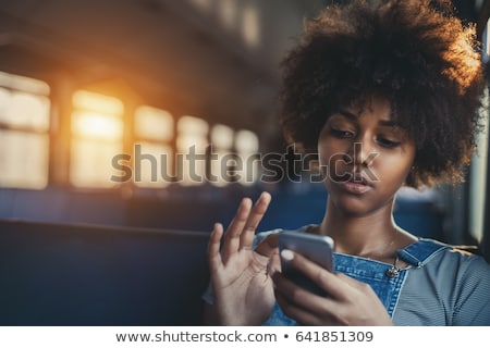 Сток-фото: Young Beautiful Thoughtful Woman Using Smartphone