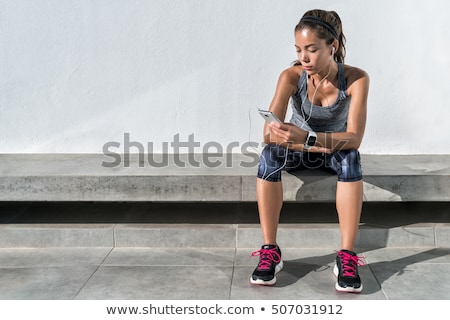 Сток-фото: Woman Sitting On A Bench In The Gym
