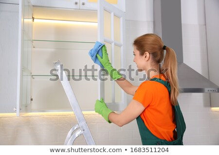 Stok fotoğraf: Janitor Cleaning Shelf With Napkin