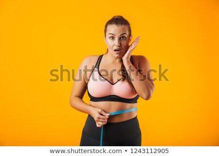 Foto stock: Portrait Of Overweight Woman In Sportive Bra Measuring Her Waist