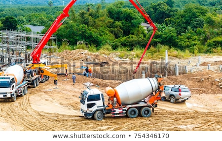 [[stock_photo]]: Excavator And Cement Mixer Industrial Machinery