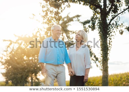 Zdjęcia stock: Couple Of Senior Woman And Man Having An Evening Stroll