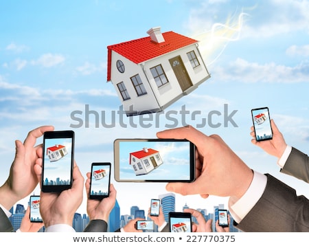 Hands Holding Smart Phones And Shoot Video As Falling House Stockfoto © cherezoff