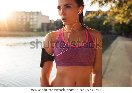 Сток-фото: Woman With Earphones And Armband Jogging At Park