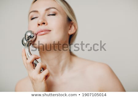 Foto stock: Beauty Girl Holding Drainage Massage Face Roller