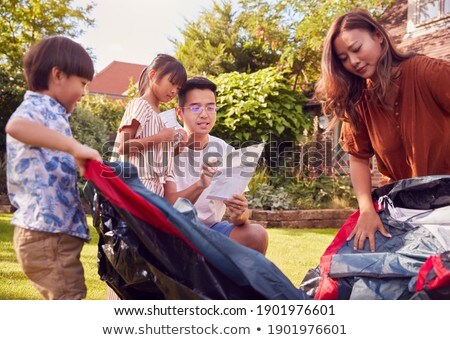 Zdjęcia stock: Father And Son Reading Instructions For Tent