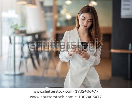 Сток-фото: Happy Asian Business Woman On Coffee Break Smiling Texting Sms Message Mobile Data Phone Or Reading