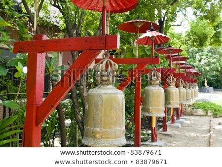 Row Of Bells In A Temple Covered By Red Umbrella Stock photo © 3523studio