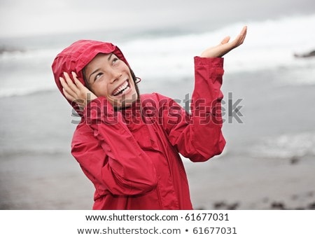 Girl Enjoying The Rain And Having Fun Outside On The Beach A Gray Rainy Foto stock © Maridav