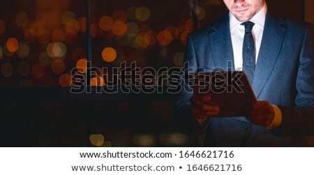 Foto stock: Crop Businessmen With Tablet In Office At Night