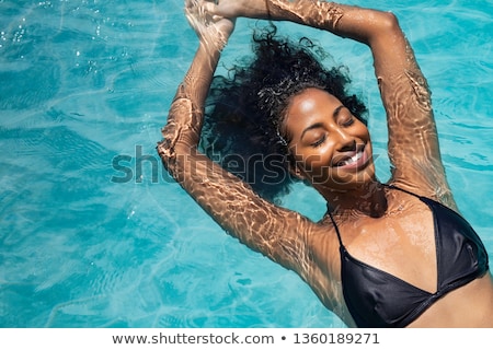 Stock foto: High Angle View Of Beautiful African American Woman Relaxing Near Swimming Pool On A Sunny Day