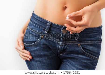 Foto stock: Woman Holding Pill In Front Of Stomach