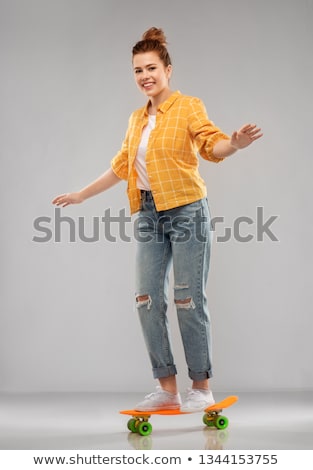 [[stock_photo]]: Red Haired Teenage Girl Riding On Short Skateboard