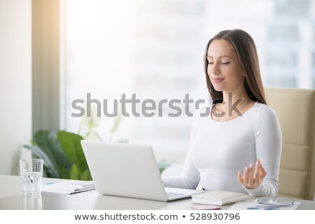 Foto stock: Businesswoman Meditating In Front Of Laptop