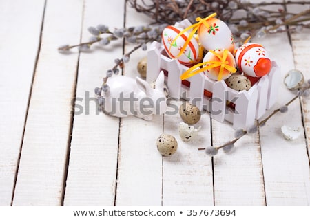 Сток-фото: Decorative Wooden Easter Eggs With Green Branch On A Beautiful L