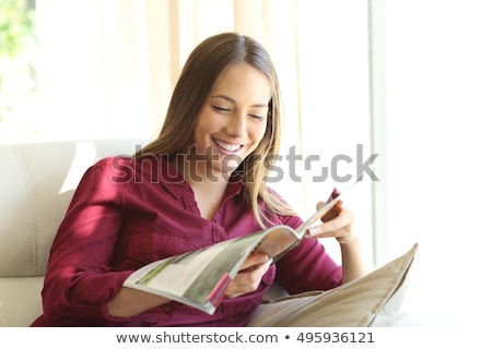 Stockfoto: Young Woman Reading Magazine