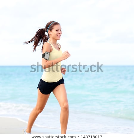 Stock photo: Woman Jogging With Earphones And Smartphone